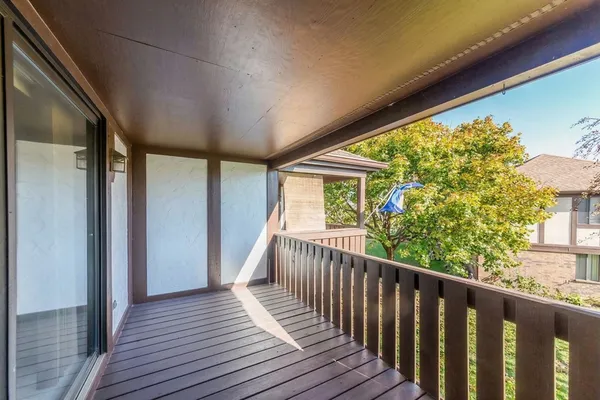 a view of balcony with wooden floor