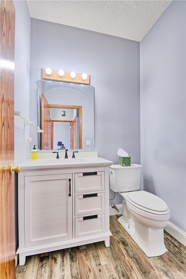 8711 Nicole Lane Springboro, OH 45066 - Photo 29 of 87 This bathroom features a contemporary vanity and toilet, complemented by rustic flooring.