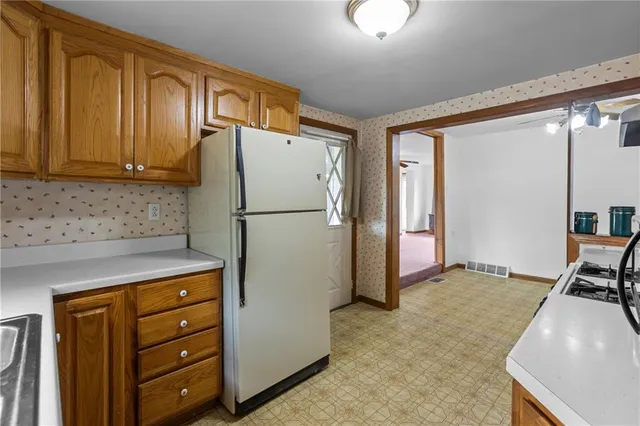 a kitchen with a refrigerator and a stove