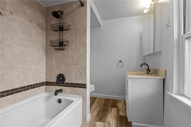 a bathroom with a tub and sink