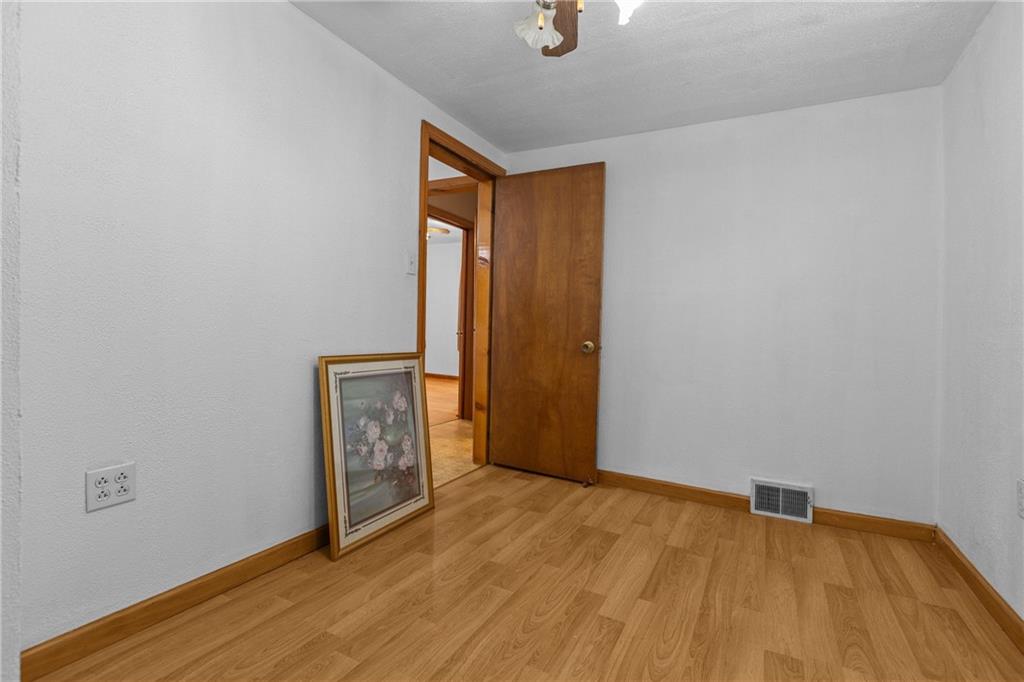 319 Center Grange Road Monaca, PA 15061 - Photo 16 of 24 a view of an empty room with wooden floor