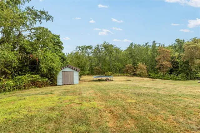 a view of a house with a backyard