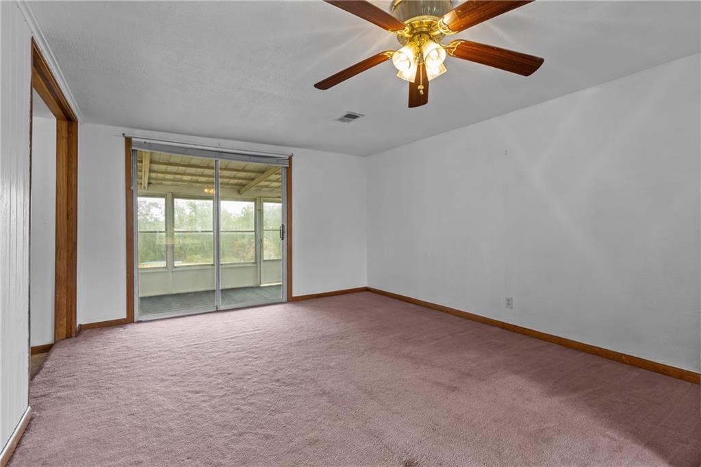 319 Center Grange Road Monaca, PA 15061 - Photo 3 of 24 an empty room with chandelier fan and windows