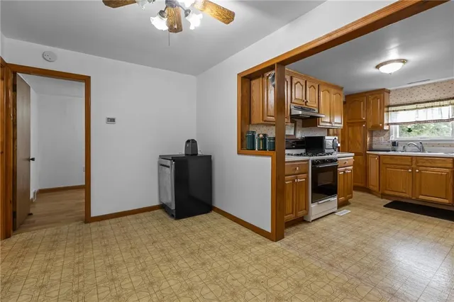 a kitchen with stainless steel appliances granite countertop a stove and a refrigerator