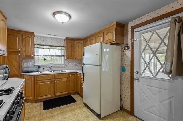 a kitchen with stainless steel appliances a refrigerator sink and cabinets