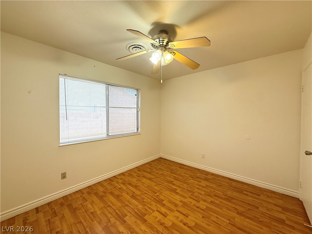 616 Greenway Road Henderson, NV 89002 - Photo 20 of 32 A well-lit bedroom features durable hardwood flooring and a functional ceiling fan.