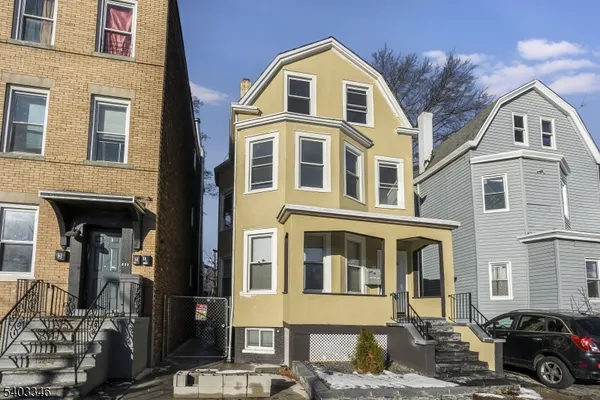 a front view of a residential apartment building with a yard