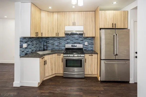 a kitchen with a refrigerator and a stove
