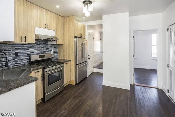 a kitchen with a refrigerator and a sink