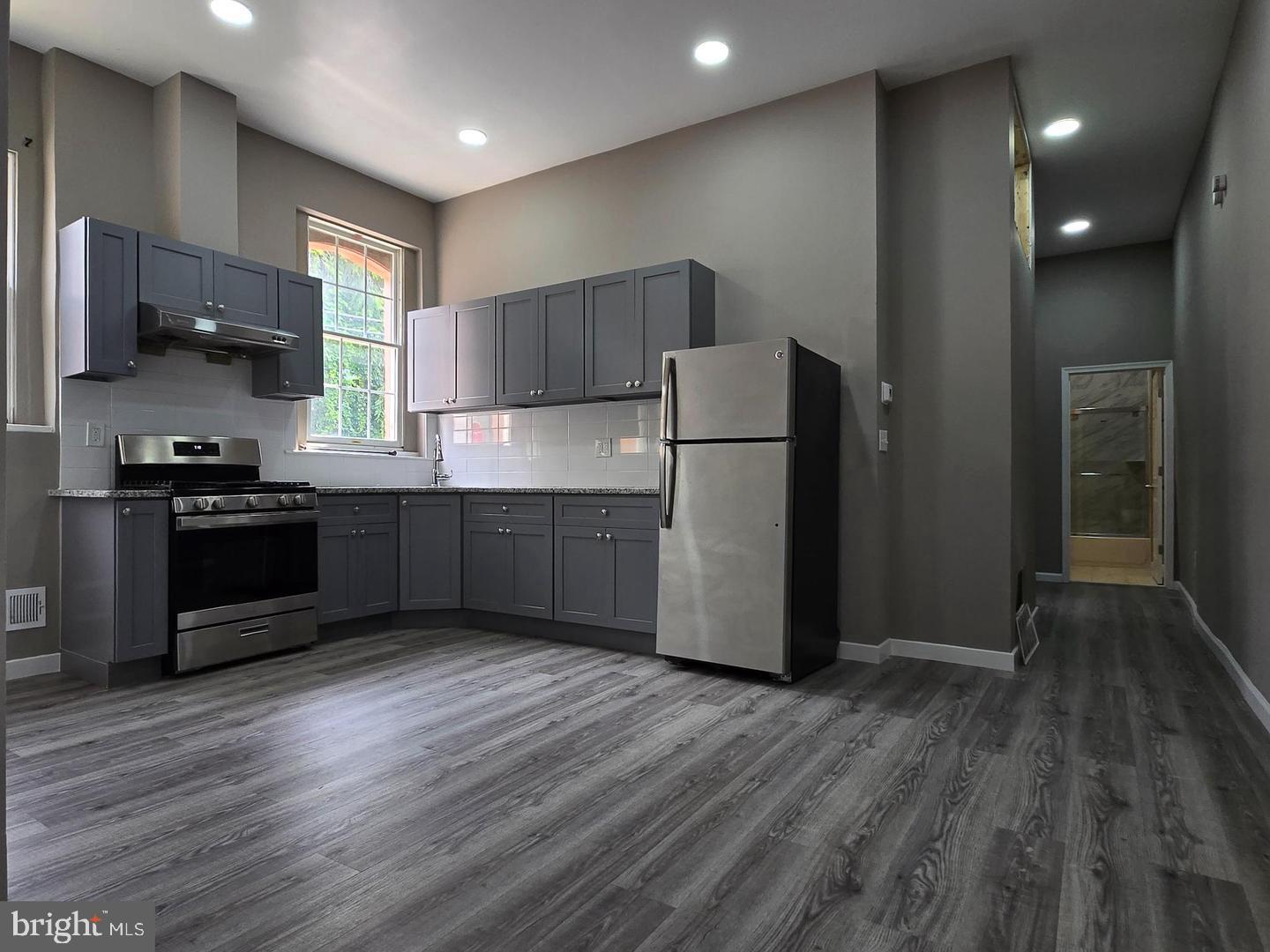 1218 North 16th Street Philadelphia, PA 19121 - Photo 1 of 33 a kitchen with stainless steel appliances a refrigerator and a stove top oven
