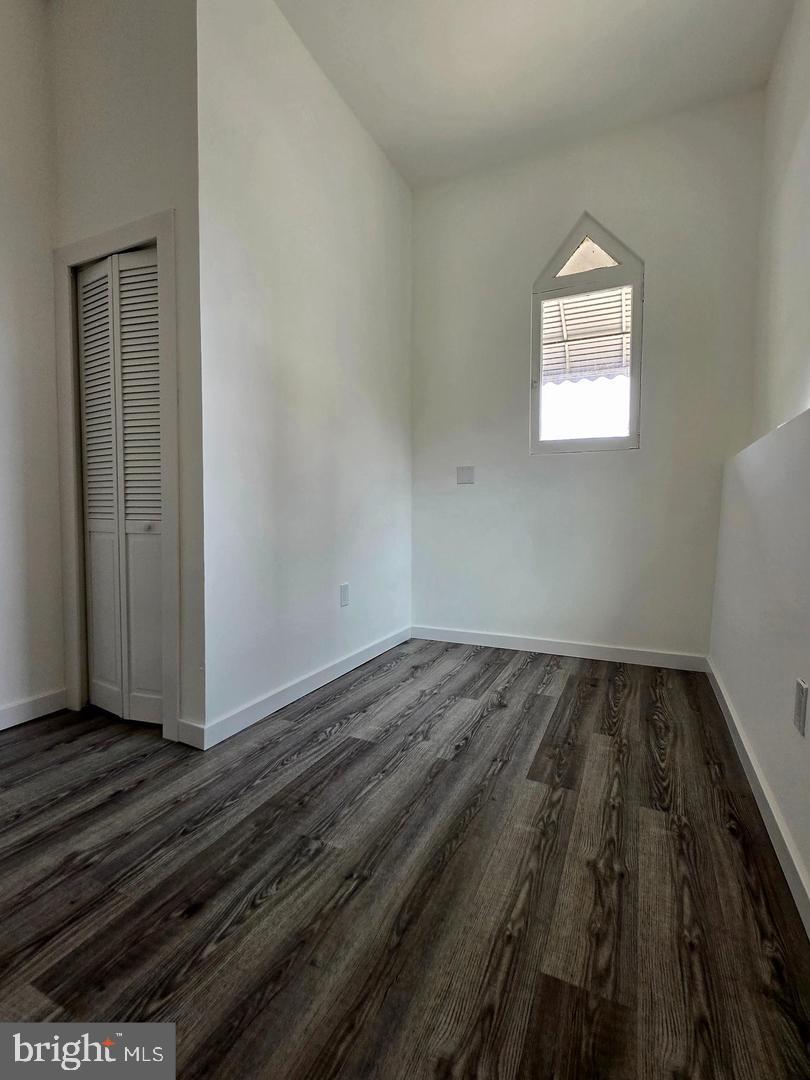 1218 North 16th Street Philadelphia, PA 19121 - Photo 13 of 33 an empty room with wooden floor and windows
