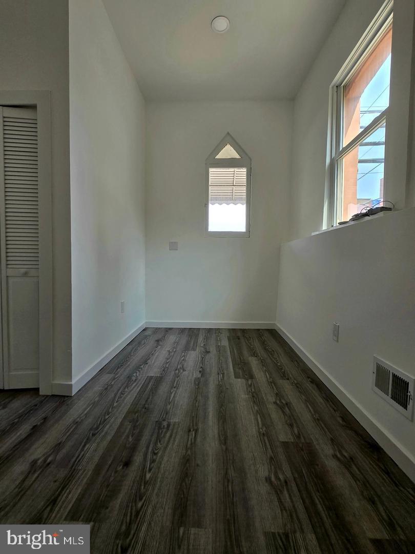 1218 North 16th Street Philadelphia, PA 19121 - Photo 15 of 33 a view of a room that has wooden floor and cabinets