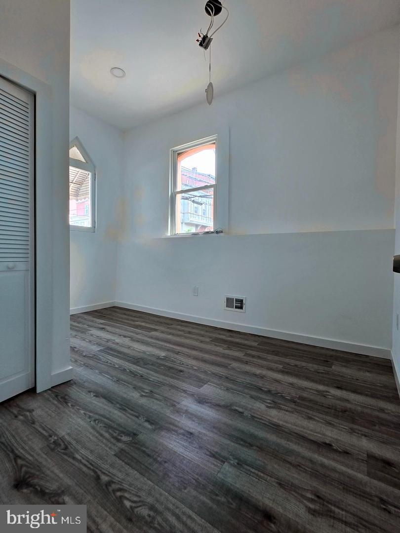 1218 North 16th Street Philadelphia, PA 19121 - Photo 16 of 33 an empty room with wooden floor and windows
