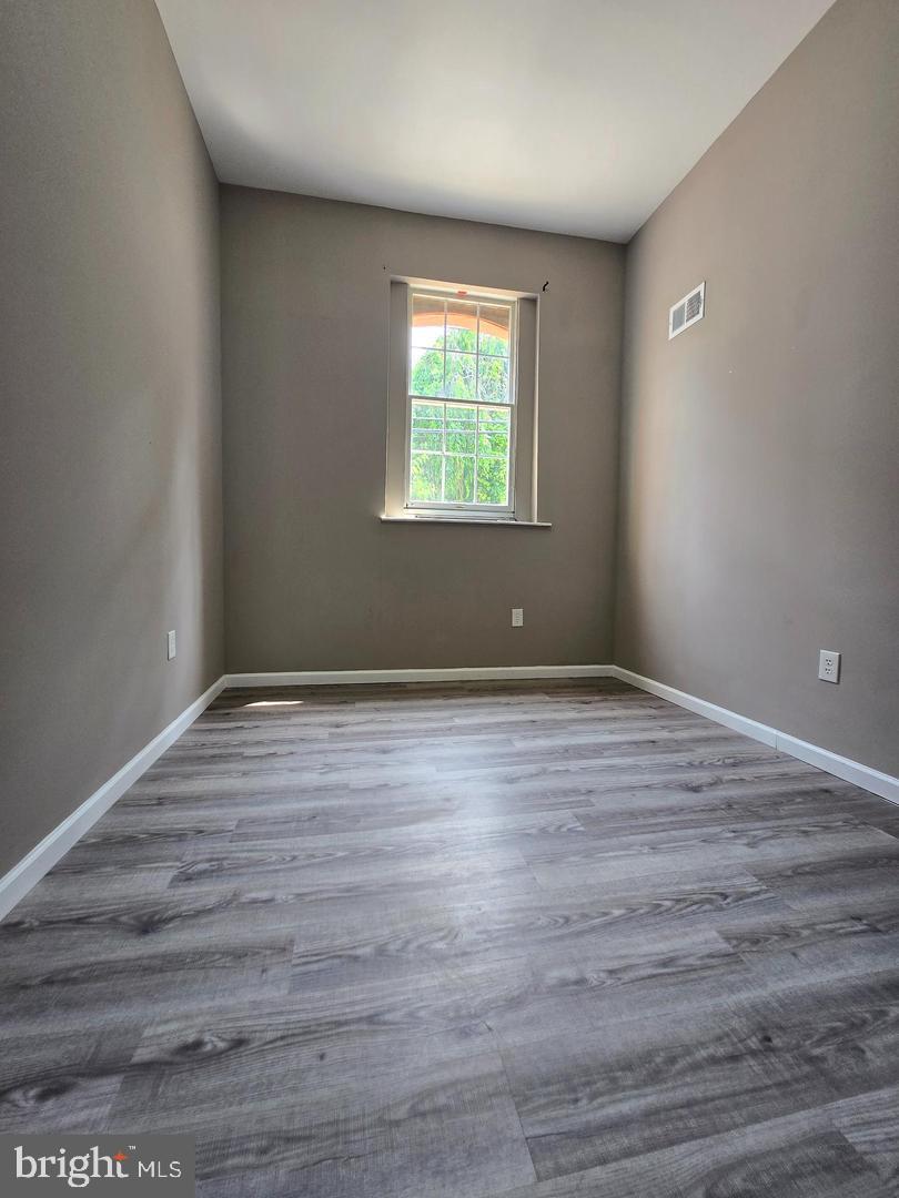 1218 North 16th Street Philadelphia, PA 19121 - Photo 17 of 33 a view of an empty room with wooden floor and a window