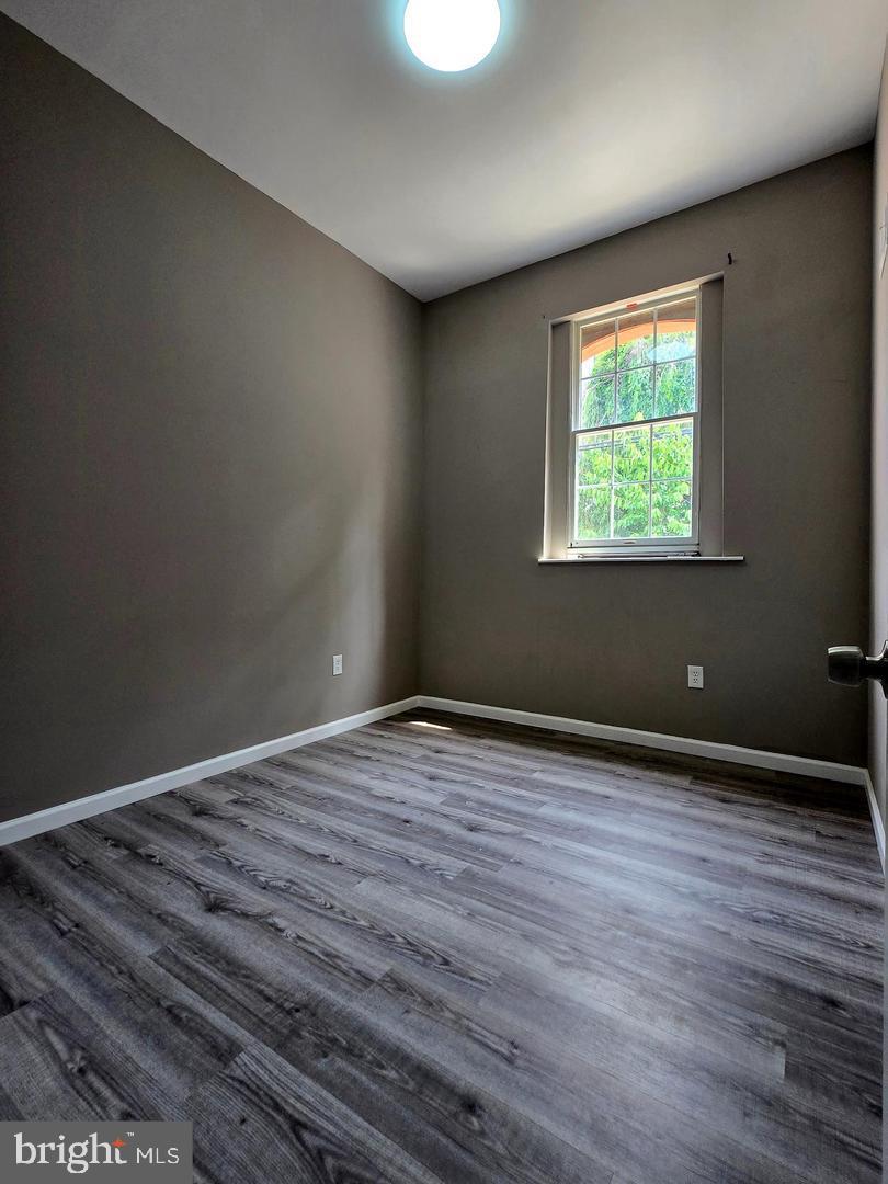 1218 North 16th Street Philadelphia, PA 19121 - Photo 20 of 33 a view of an empty room with wooden floor and a window