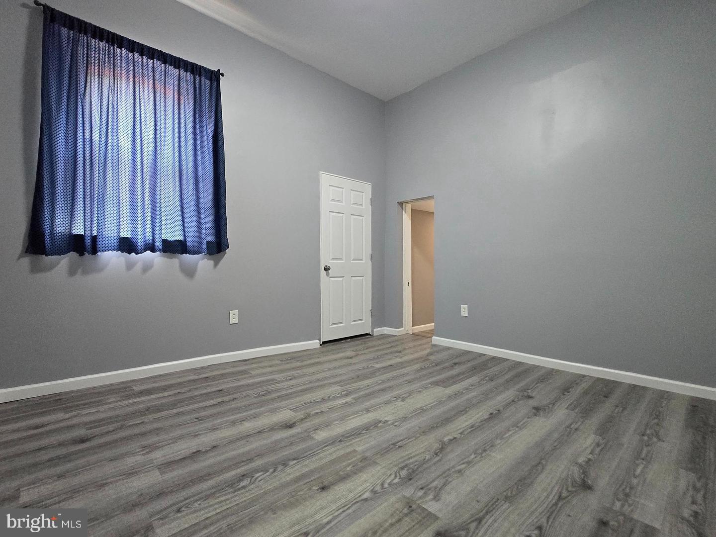 1218 North 16th Street Philadelphia, PA 19121 - Photo 23 of 33 an empty room with wooden floor and windows