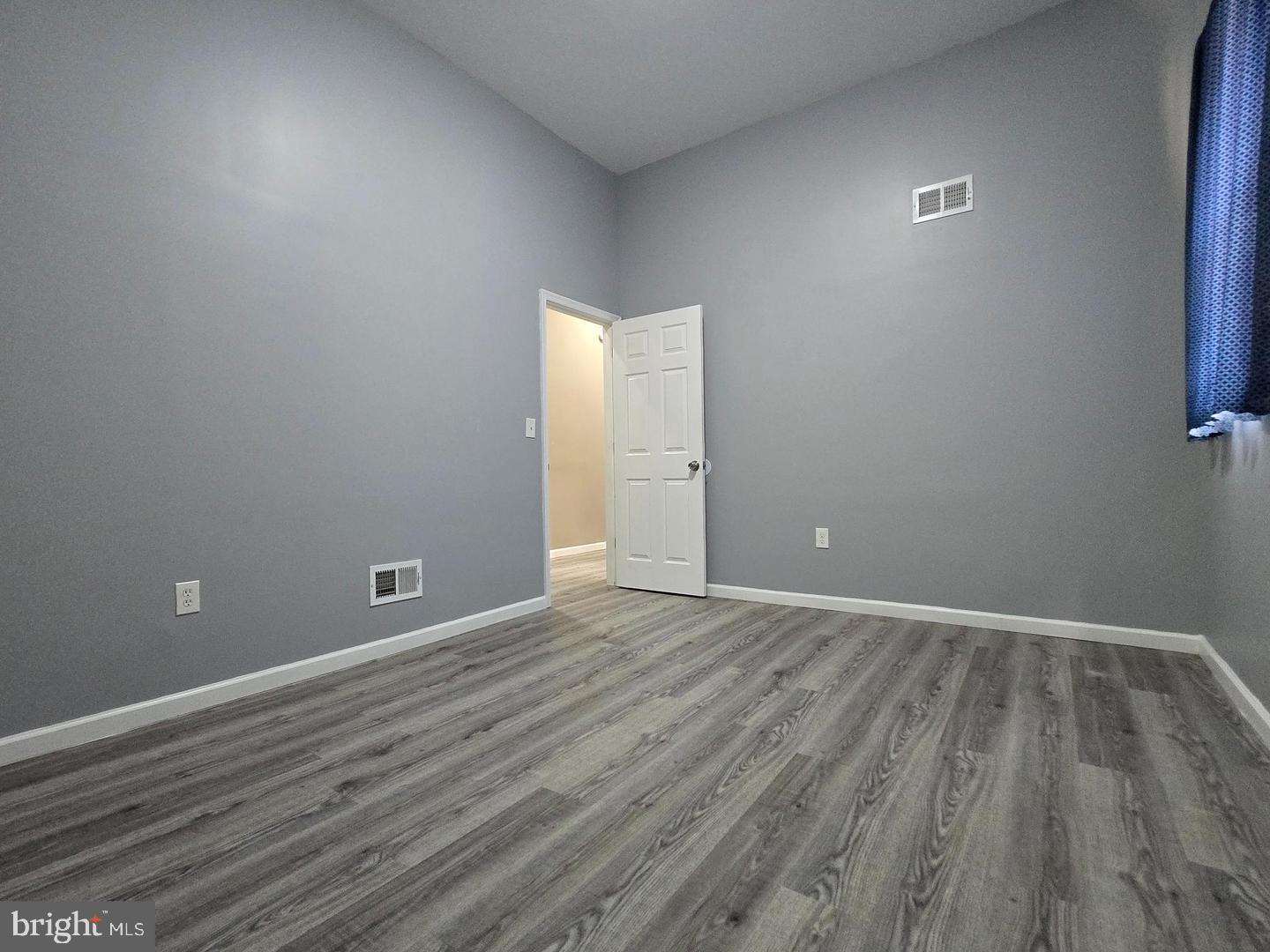 1218 North 16th Street Philadelphia, PA 19121 - Photo 25 of 33 a view of an empty room with wooden floor and a window