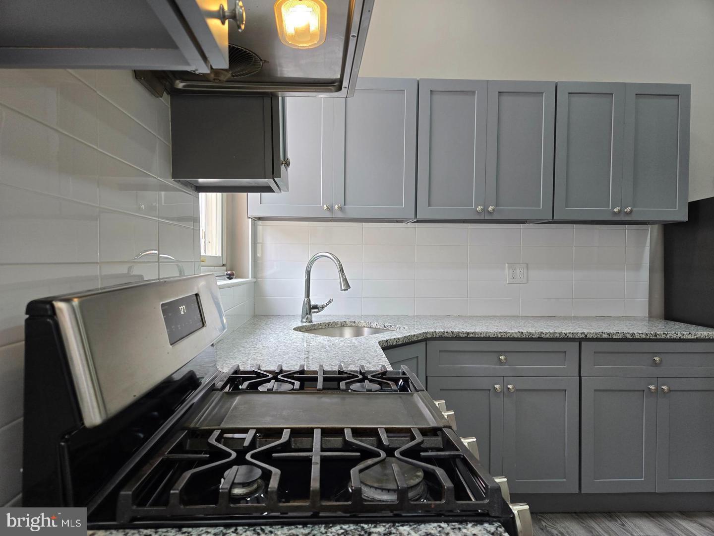 1218 North 16th Street Philadelphia, PA 19121 - Photo 5 of 33 a kitchen with a stove and a microwave
