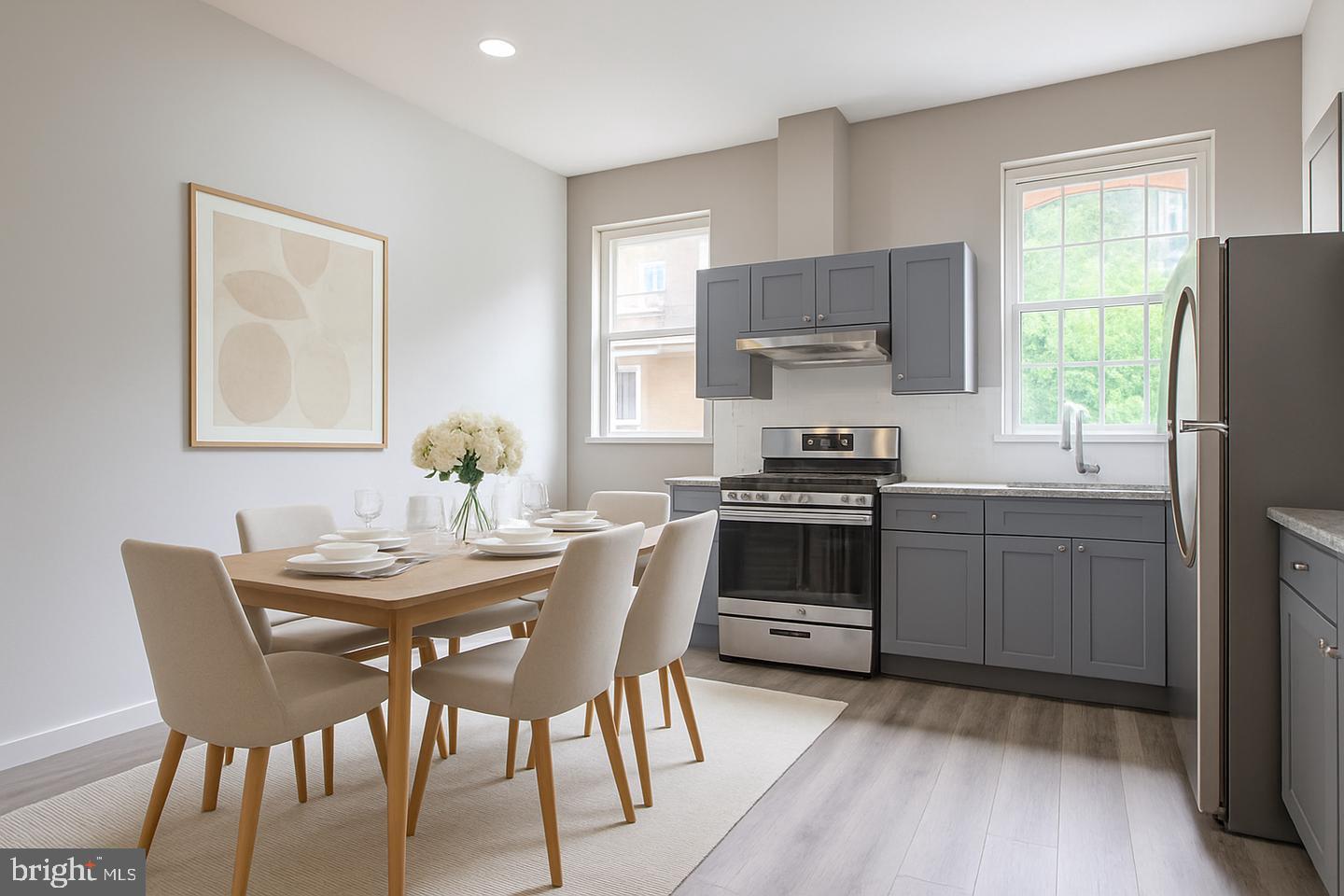 1218 North 16th Street Philadelphia, PA 19121 - Photo 8 of 33 a kitchen with a dining table chairs and refrigerator
