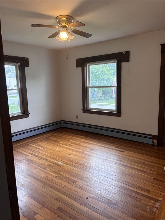 349 Oak Street Clinton, MA 01510 - Photo 4 of 9 a view of an empty room with wooden floor and a window