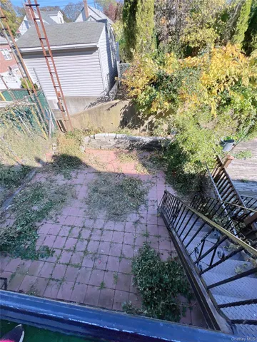 a view of a backyard with wooden fence