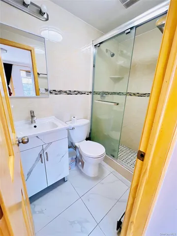 a bathroom with a sink mirror vanity and toilet
