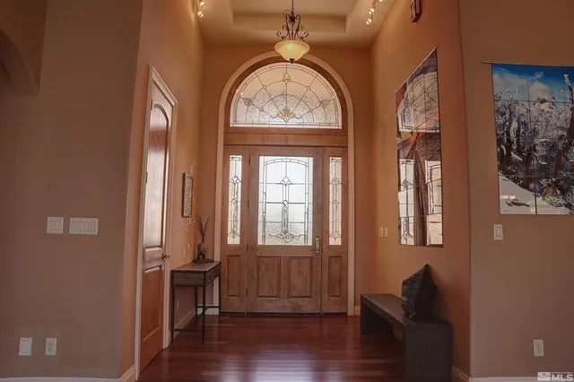a view of entryway with wooden floor and a front door