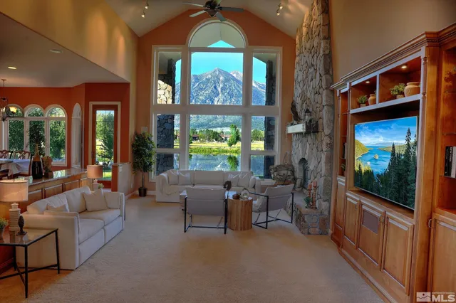 a living room with furniture a fireplace and a flat tv screen