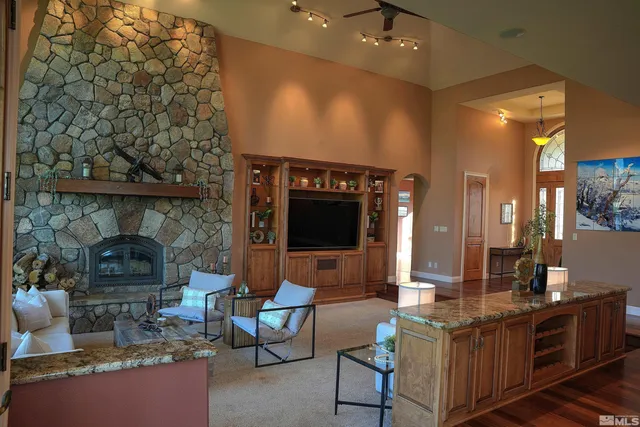a living room with furniture a fireplace and a flat screen tv