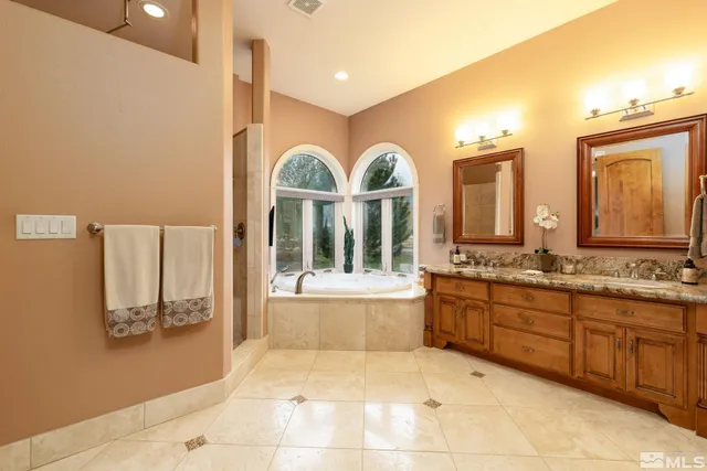 a white bath tub sitting in a bathroom next to a window