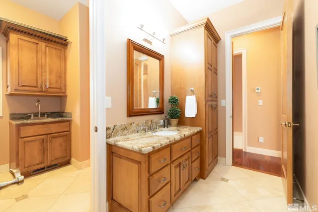 a kitchen with granite countertop a white cabinets and window