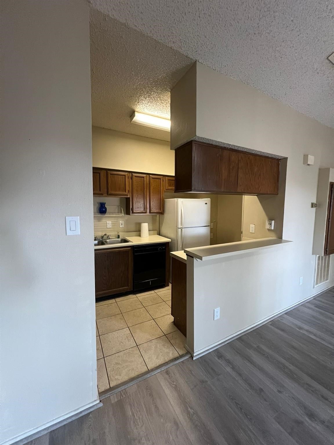 17417 Red Oak Drive, Unit 106 Houston, TX 77090 - Photo 2 of 7 a kitchen with a sink cabinets and wooden floor