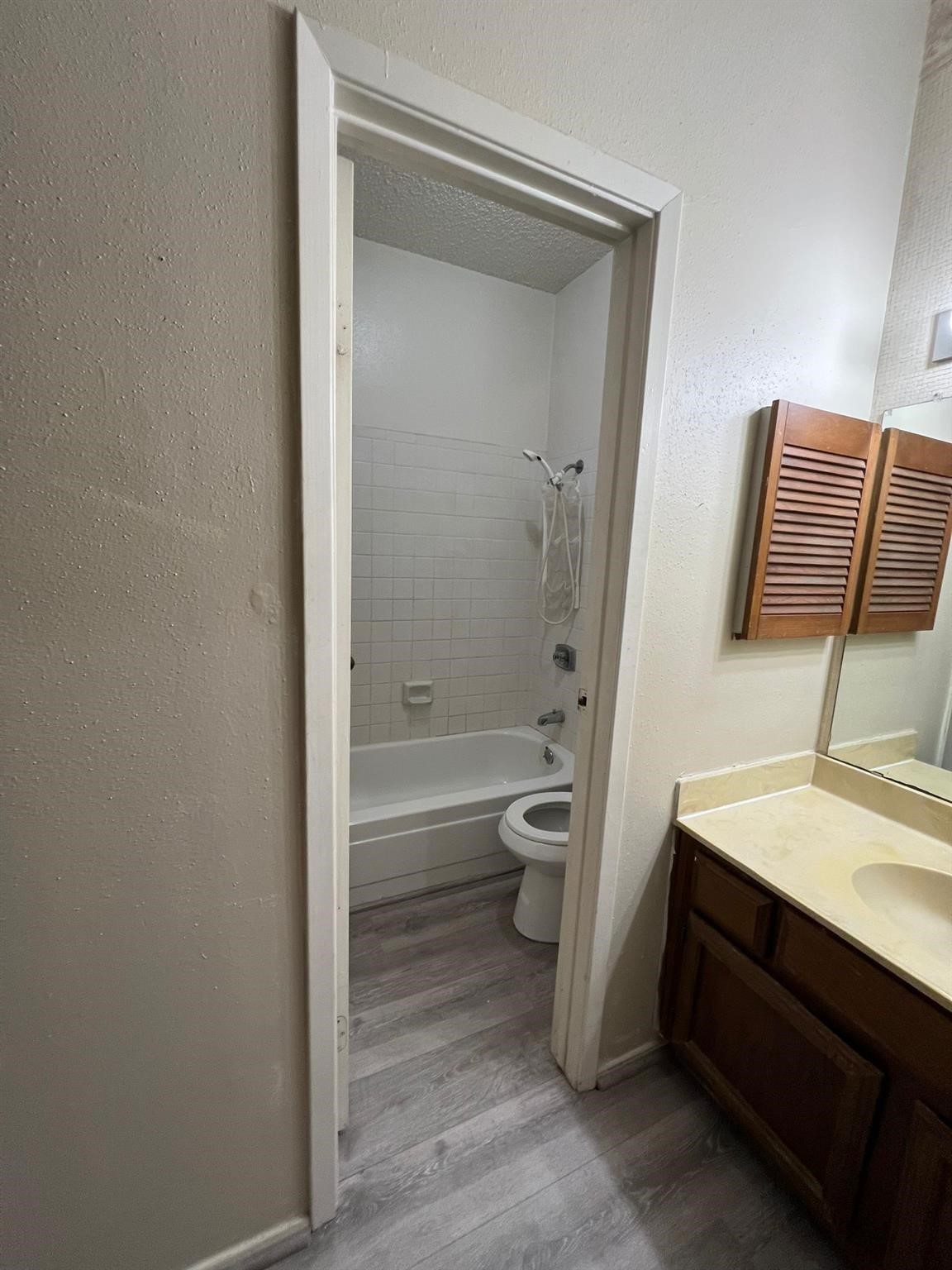 17417 Red Oak Drive, Unit 106 Houston, TX 77090 - Photo 7 of 7 a bathroom with a sink a toilet and shower