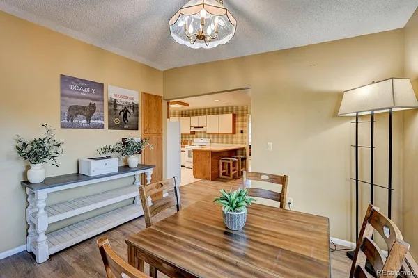 a view of a dining room with furniture and a potted plant