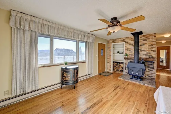 a living room with furniture a window and a flat screen tv