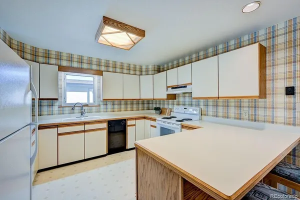 a kitchen with a sink a stove and cabinets