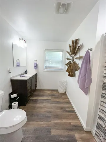 a bathroom with a sink toilet and a mirror
