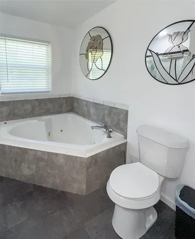 a bathroom with a bathtub and a toilet