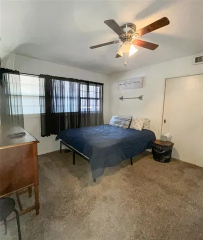 a bed sitting in a room next to a window