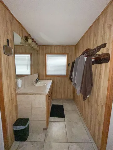 a bathroom with a sink a mirror and a shower