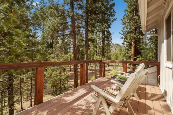 a view of balcony with wooden floor and fence