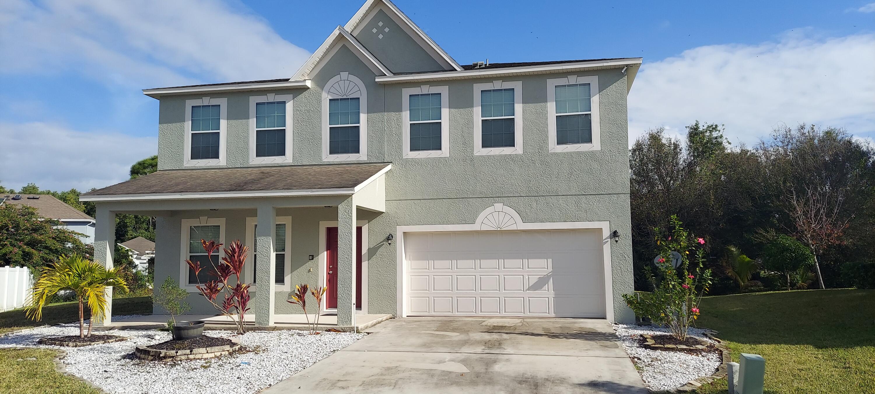6101 Northwest Butterfly Orchid Place Port St. Lucie, FL 34986 - Photo 1 of 35 a front view of a house