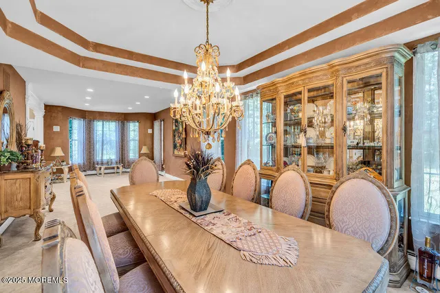 a large kitchen with stainless steel appliances kitchen island granite countertop a sink counter space and a view of living room