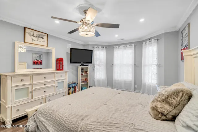 a spacious bedroom with a bed and a chandelier