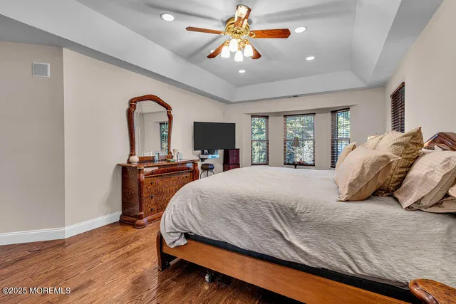 a white bath tub sitting in a bathroom next to a window