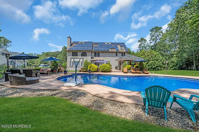 a view of a patio with table and chairs under an umbrella