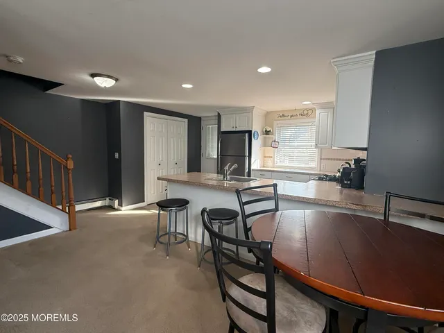 a kitchen with a table chairs and microwave
