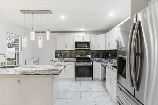 a kitchen with a stove a sink and a refrigerator