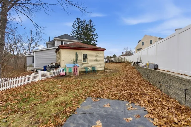 a backyard of a house with table and chairs