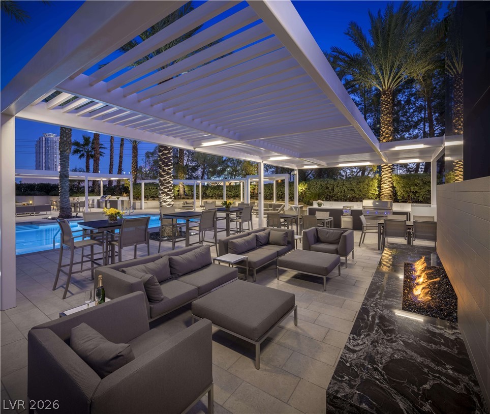 2777 Paradise Road, Unit 807 Las Vegas, NV 89109 - Photo 61 of 61 An inviting outdoor oasis with a fireplace and ample seating areas, perfect for evening gatherings.